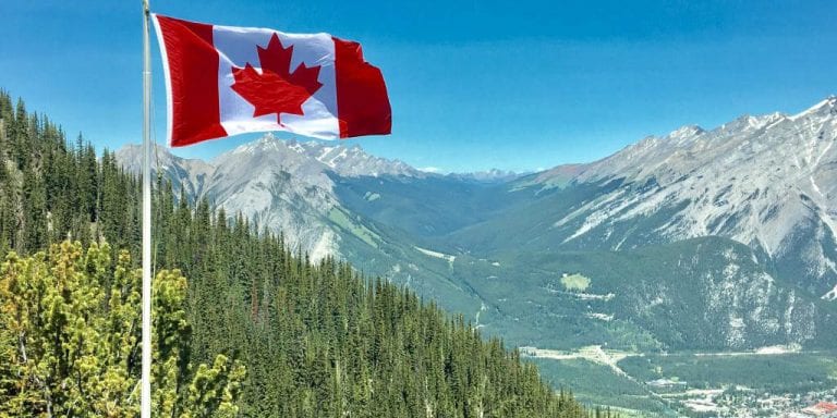 Flag of Canada in front of mountains